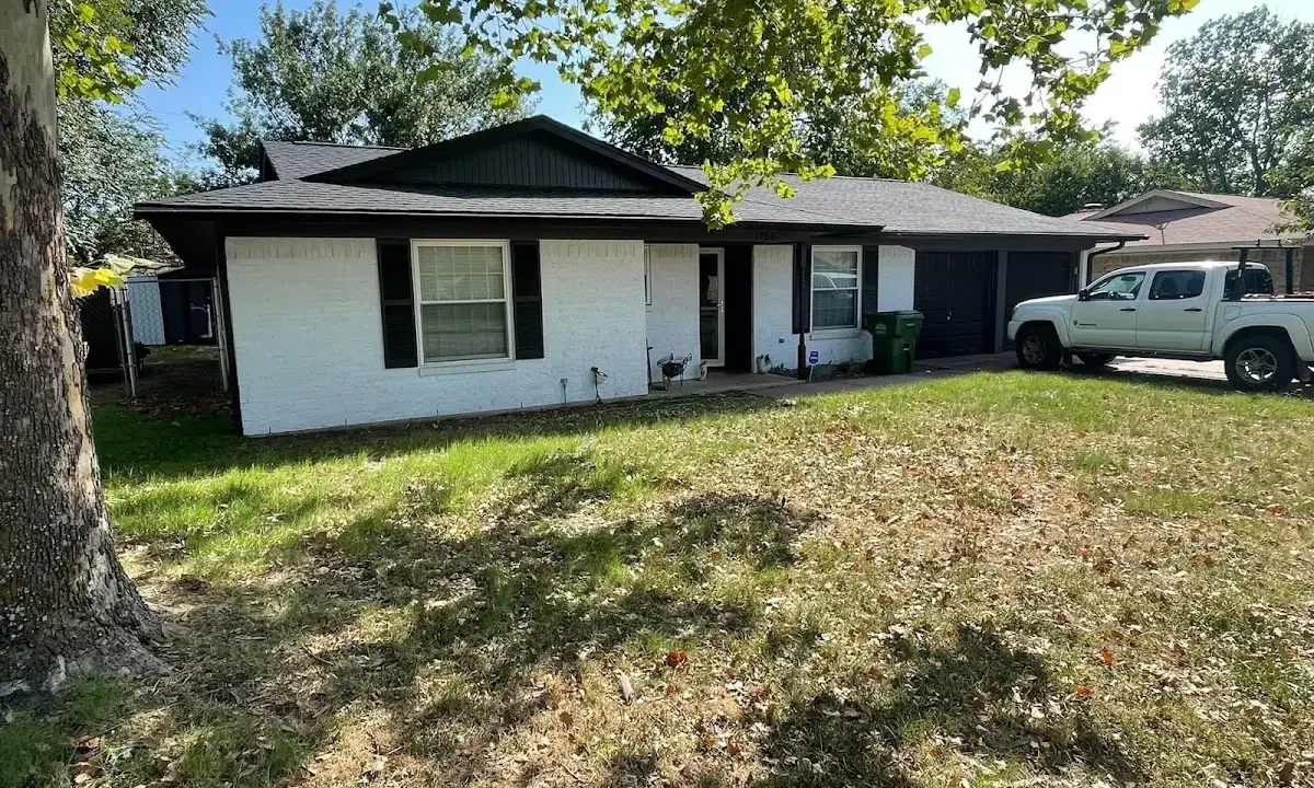 Professional roofing crew working on a residential roof in Zachary